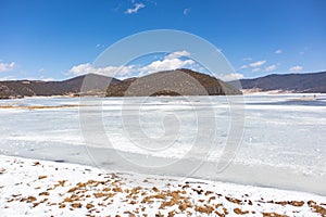 Potatso National Park or Pudacuo National Park during winter with mountain and frozen lake scenery with snow covered ground