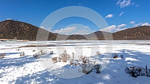 Potatso National Park or Pudacuo National Park during winter with mountain and frozen lake scenery with snow covered ground