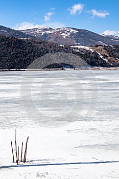 Potatso National Park or Pudacuo National Park during winter with mountain and frozen lake scenery with snow covered ground