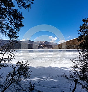 Potatso National Park or Pudacuo National Park during winter with mountain and frozen lake scenery with snow covered ground