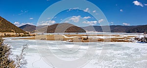 Potatso National Park or Pudacuo National Park during winter with mountain and frozen lake scenery with snow covered ground