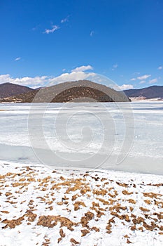 Potatso National Park or Pudacuo National Park during winter with mountain and frozen lake scenery with snow covered ground