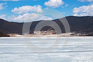 Potatso National Park or Pudacuo National Park during winter with mountain and frozen lake scenery with snow covered ground