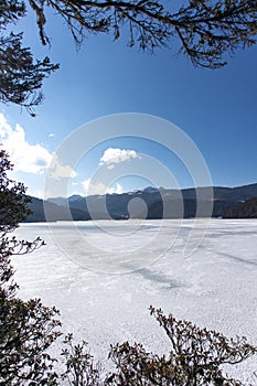 Potatso National Park or Pudacuo National Park during winter with mountain and frozen lake scenery with snow covered ground