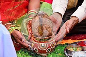 Pote and coconut with man and woman hand photo