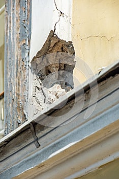 Pothole in the facade of a vintage building is close