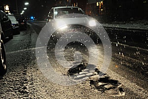 Potholes with car at night photo