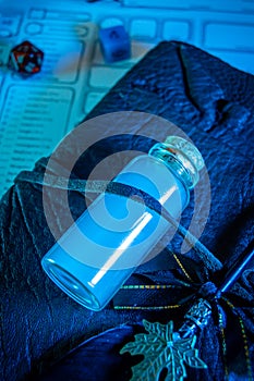 Potion of mist form in a glass bottle on a leather bound journal