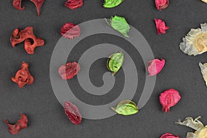 Potpourri on a black background. Flavored potpourri leaves. Dry potpourri leaves close-up. Geometric pattern. Closeup.