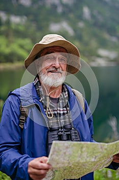 Potrait of active senior man hiking in autumn mountains.
