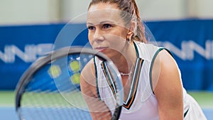 Potrait of Female Tennis Player Holding the Racquet During Championship Match, Ready to Receive Ball