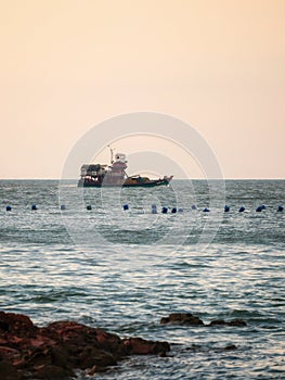 fishing boat returning to habour from open sea photo