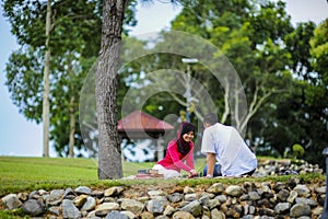 Potrait of happy young couple enjoying a day in park together