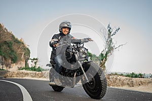 potrait indonesian man riding motorbike outdoors