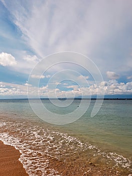 potraits view of greenish blue sea water and brown sand at Angso Duo Island photo