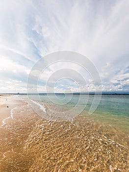 potraits view of greenish blue sea water and cloudy sky photo