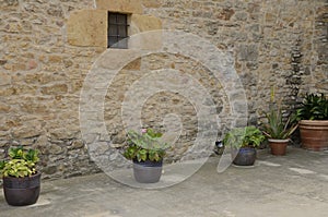 Pots next to stone wall