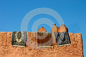 Pots and rugs drying in sun photo