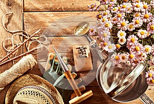 Potted pink daises, gardening tools and sunhat