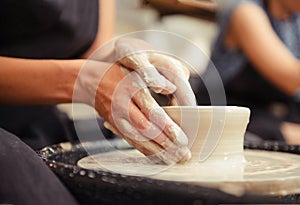 Potter, clay, workshop, Woman`s hands making pottery circle