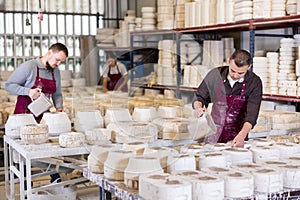 Potter filling casting molds with slip to shape ceramic products