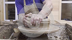 Potter forms plate out of clay. Stock footage. Men`s hands of professional Potter form container of clay on Potter`s
