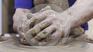 Potter forms plate out of clay. Stock footage. Men`s hands of professional Potter form container of clay on Potter`s