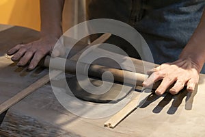 potter hands at work in workshop