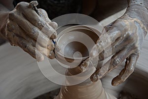 Potter makes earthen lamps or â€˜diyasâ€™ ahead of the forthcoming Diwali festival