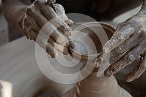 Potter makes earthen lamps or â€˜diyasâ€™ ahead of the forthcoming Diwali festival