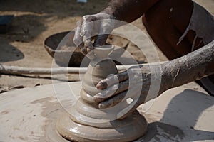 Potter makes earthen lamps or â€˜diyasâ€™ ahead of the forthcoming Diwali festival