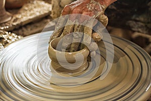 Potter makes on the pottery wheel