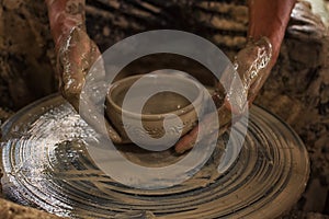 Potter makes on the pottery wheel