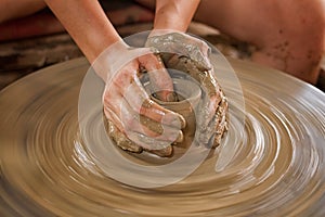 Potter makes on the pottery wheel