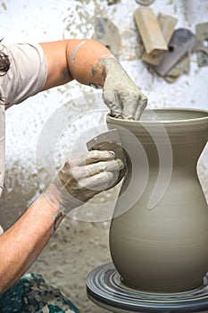 A potter makes a vase out of clay