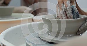 Potter making ceramic pot on pottery wheel