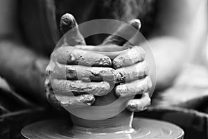 Potter making ceramic pot on the pottery wheel