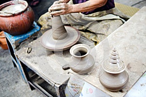 Potter man hands shaping ceramic craft