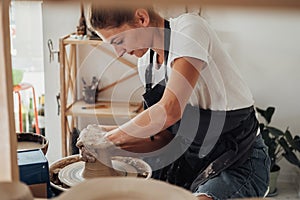 Potter Master at Work, Young Caucasian Woman Creating Clay Pot on a Pottery Wheel in Her Studio