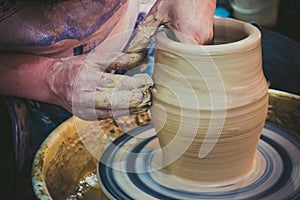 The potter molds clay jug pot closeup
