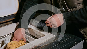 Potter placing ceramic wares in pottery kiln