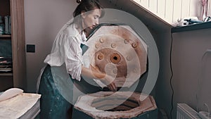 Potter preparing the pottery kiln for the baking process for her dish