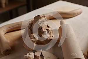 Potter's clay and tools on the workbench