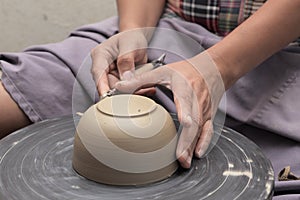 Potter's hand shaping bowl