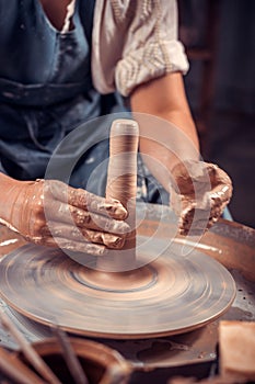 Potter& x27;s hands and potter& x27;s wheel. Close-up.