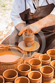 Potter`s hands shaping up the clay