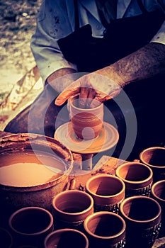 Potter`s hands shaping up the clay