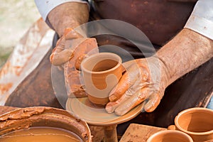 Potter`s hands shaping up the clay