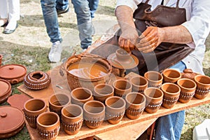 Potter`s hands shaping up the clay