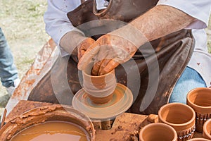 Potter`s hands shaping up the clay